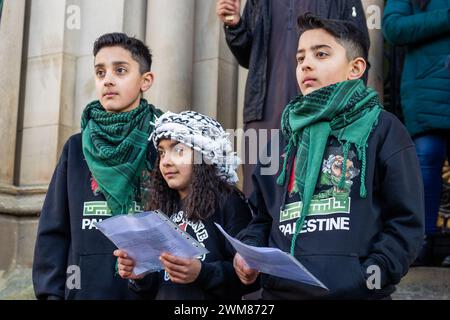 Bradford, UK. 24 FEB, 2024. Young children perform a song for Palestine to the assembled crowd at Centenary Square, Bradford.  Credit Milo Chandler/Alamy Live News Stock Photo