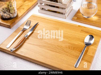 Set of cutlery knife, spoon and fork. Modern table setting on restaurant table Stock Photo