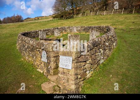 The Riley graves and tomb enclosed by a stone wall,  the graves of the whole Hancock family. who all died of plague in Eyam Peak District Derbyshire Stock Photo
