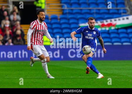 Cardiff, UK. 24th Feb, 2024. Joe Ralls, Captain of Cardiff City (r) in action during the EFL Skybet championship match, Cardiff City v Stoke City at the Cardiff City Stadium in Cardiff, Wales on Saturday 24th February 2024. This image may only be used for Editorial purposes. Editorial use only, pic by Credit: Andrew Orchard sports photography/Alamy Live News Stock Photo