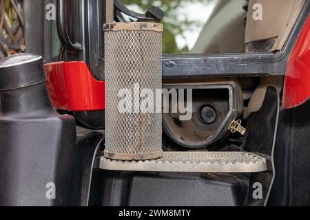 Dirty air filter for cab of farm tractor. Agriculture and farming equipment repair, maintenance and service concept Stock Photo