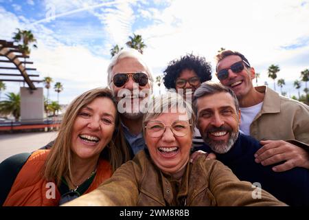 Happy selfie of a group of mature friends having fun outdoors. Stock Photo