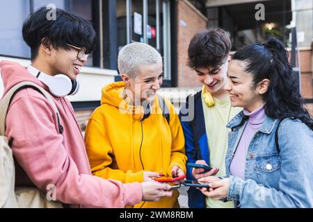Group of multiracial teenage students using mobile phones on high school Stock Photo