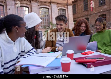 Group of students, high school pupils gather in college cafeteria, discuss topics, work together Stock Photo