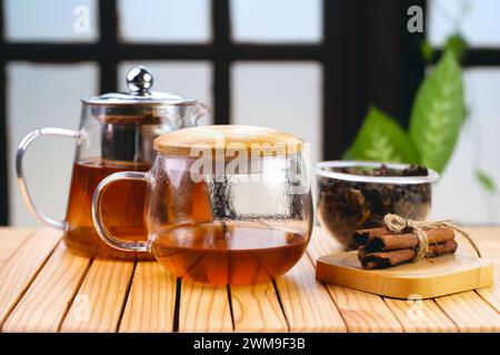 Hot herbal tea drink in glass composition with cinnamon on a wooden pallet Stock Photo