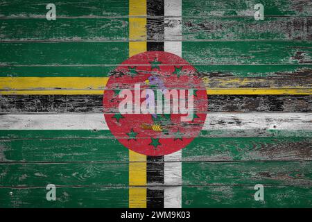 The national flag of  Dominica  is painted on uneven wooden  boards. Country symbol. Stock Photo