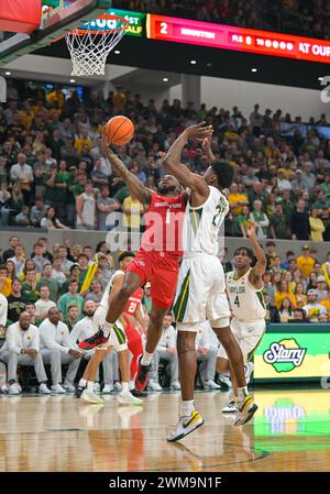 Houston guard Jamal Shead (1) shoots as BYU center Aly Khalifa (50 ...