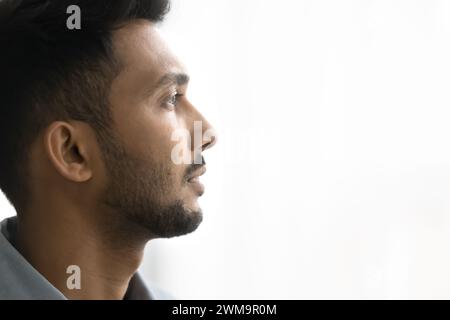 Close up profile face of pensive handsome Indian man Stock Photo