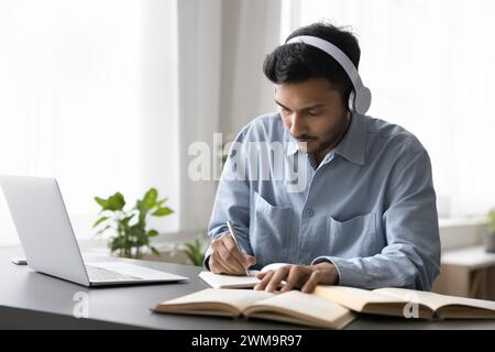Young Indian man studying on-line using laptop Stock Photo