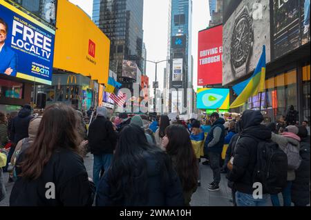 NEW YORK, NEW YORK - MARCH 19: People gather for a rally for Ukraine on the second anniversary of the Russian invasion of Ukraine at Times Square on February 24, 2024 in New York City. Entering its third year, Russia's unyielding war on Ukraine has raised concerns about how long Western countries will continue providing weapons and other support to Kyiv. The supply of ammunition, arms, and manpower is now a critical factor in a conflict that has claimed over half a million casualties, and caused the widespread displacement of civilians. Stock Photo