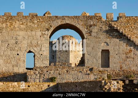 Part of an old castle wall with arches and window openings under a clear blue sky, sea fortress Methoni, Peloponnese, Greece Stock Photo