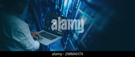 Cybersecurity innovations concept Engineer computer working with laptop computer show pad lock icon in the modern server room network background Stock Photo