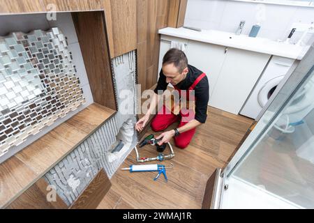 Construction man using hammer and tool while demolish wall Stock Photo