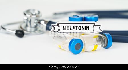 Medical concept. On the table there is a stethoscope, injections and a sign with the inscription - Melatonin Stock Photo