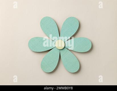 beautiful flower shaped wooden decor isolated on beige color paper background, top view Stock Photo