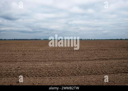 The horizon shows where tilled earth meets the sky. Stock Photo