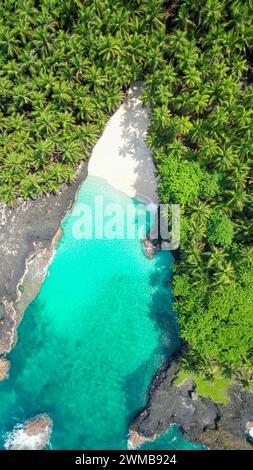 Vertical aerial view from the amazing bateria beach with the crystal clear sea at ilheu das  rolas at Sao tome e Principe,Africa Stock Photo