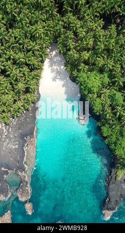 Vertical aerial view from the amazing bateria beach with the crystal clear sea at ilheu das  rolas at Sao tome e Principe,Africa Stock Photo