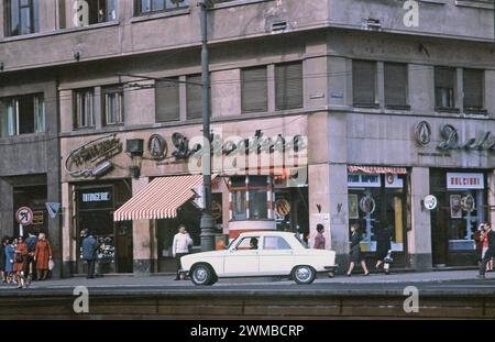 Bucharest, Romania, approx. 1979.  A daily scene in downtown Bucharest. On the sidewalk, at the street corner, a red and white Police (Militia) observational post. Stock Photo