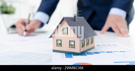 Real estate agent signs the contract. Loan or home mortgage Stock Photo