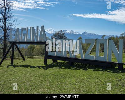 Large wooden letters buliding the words 'Laguna Corazon', parking lot at trail to heart-shaped lake Laguna Corazon, near Liquine, Chile Stock Photo