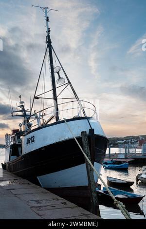 Black & white image of a trawler berthed at fish quay for repairs at Teignmouth, devon on the the river Teign. Stock Photo