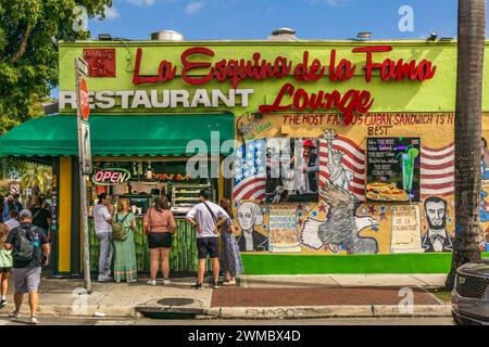 Miami, FL - US - Feb 10, 2024 Tourists at a walk up window ordering food from vibrant La Esquina de la Fama Restaurant and Lounge on Calle Ocho in Lit Stock Photo