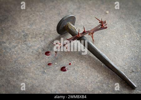 Cross made of old nail and thorn, drops of blood. Jesus Christ Crucifixion abstraction, Good Friday, religious background Stock Photo