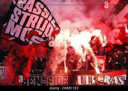 ALKMAAR - Supporters set off fireworks during the Dutch Eredivisie match between AZ Alkmaar and Ajax Amsterdam at the AFAS stadium on February 25, 2024 in Alkmaar, the Netherlands. ANP MAURICE VAN STEEN Stock Photo