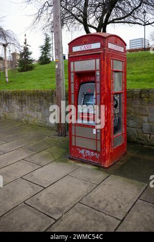 Traditional phone kiosk repurposed as a cash machine and phone in the centre of Sunderland Stock Photo