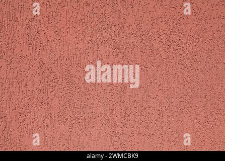 Red wall, texture, background. Plastered building wall. Rough,  textured and decorated surface with vertical embossed pattern Stock Photo