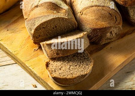 A sliced Australian dark bread over a wooden table Stock Photo