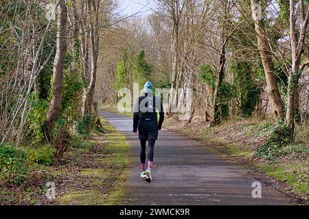 Glasgow, Scotland, UK. 25th February, 2024. UK Weather:  Warm day saw spring weather for locals on the old railway cycle path in scotstoun. Credit Gerard Ferry/Alamy Live News Stock Photo