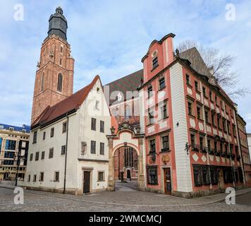 An ancient row of houses with adjacent tower in Wroclaw Stock Photo