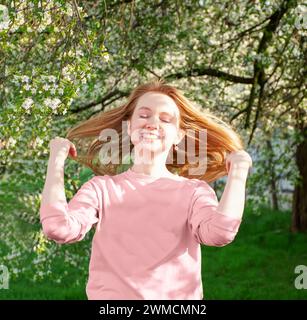 happy girl laughing, red hair fluttering in the wind Stock Photo