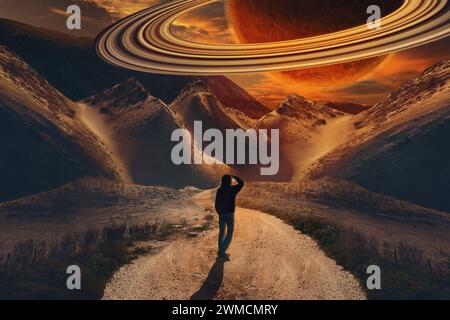 man looks into the sky at the giant planet Saturn in the sky. the influence of the planet Saturn in the natal chart on a person. collage. Stock Photo