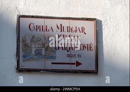 A wall street direction sign made with painted ceramic tiles of the Capilla Mudejar Igla san Bartolome siglo (Chapel of San Bartolome) in the old Jewi Stock Photo