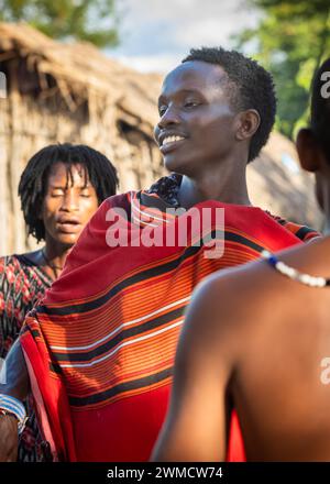 A young Maasai warrior performs the traditional jumping dance in his village in Mikumi, Tanzania Stock Photo
