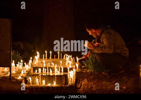 Srinagar, India. 25th Feb, 2024. A Kashmiri Shiite Muslim light candles on the grave of a relative to mark Lailat al-Barat (night of salvation), one of five holy nights of the Muslims as the night of fortune and forgiveness in Srinagar. Muslims visit graveyards for the salvation of departed souls and consider Lailat al-Barat to be the night of forgiveness. Credit: SOPA Images Limited/Alamy Live News Stock Photo
