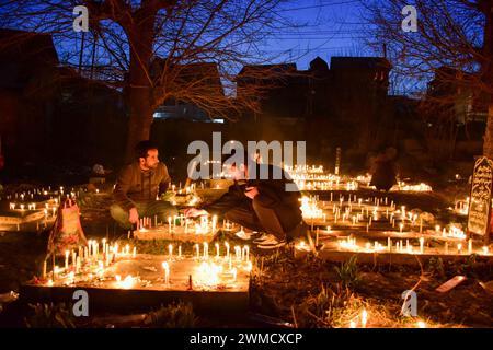 Srinagar, India. 25th Feb, 2024. Kashmiri Shiite Muslims light candles on the graves of their relatives to mark Lailat al-Barat (night of salvation), one of five holy nights of the Muslims as the night of fortune and forgiveness, in Srinagar. Muslims visit graveyards for the salvation of departed souls and consider Lailat al-Barat to be the night of forgiveness. Credit: SOPA Images Limited/Alamy Live News Stock Photo