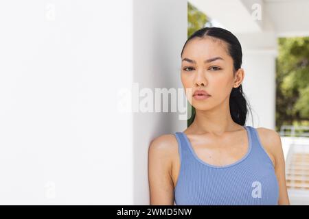 A young biracial woman poses confidently, with copy space Stock Photo