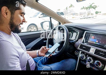 Merida Mexico,Xcumpich Calle 20A,taxi cab taxicab driver,man men male,adult adults,resident residents,working checking reading mobile cell phone,insid Stock Photo