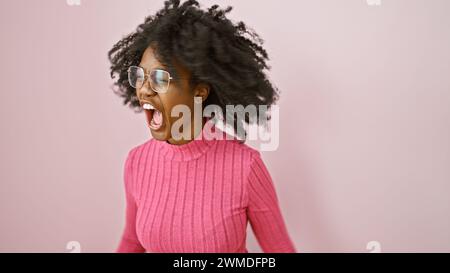 African american woman screaming in an indoor setting with expressive face and windswept hair. Stock Photo