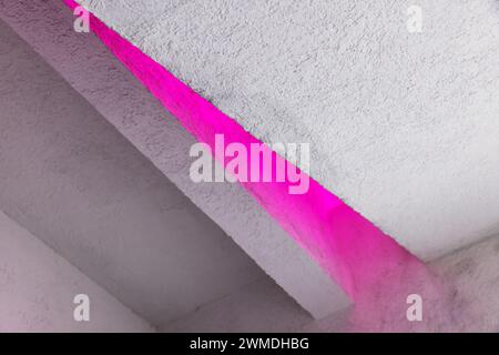 Minimal white interior background with purple illumination in a corner of a niche. Abstract contemporary architectural photo Stock Photo
