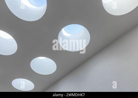 Round ceiling skylight portals with blue sky behind in a white room, abstract minimal architecture background photo Stock Photo