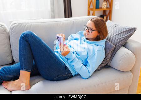 Casual Home Relaxation with Smartphone Stock Photo