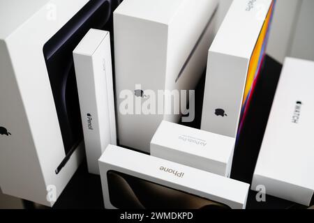 BERLIN , GERMANY - FEBRUARY 14 2024: Top view on the white boxes from MacBook Pro, Apple pencil, iPad, watch, and iPhones boxes on the table. Stock Photo