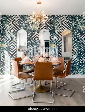 Kitchen dining table set with bowls plates napkins trendy wallpaper Stock Photo