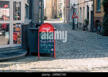 Gent, Belgium - January 31 2024: Vibrant flavors of authentic Indian cuisine on this menu. Indian restaurant displaying menu on street in europe Stock Photo