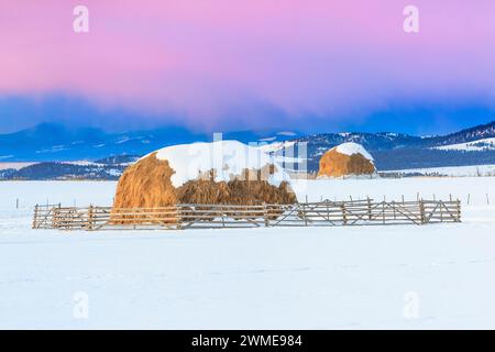 sunrise over haystacks in winter near avon, montana Stock Photo